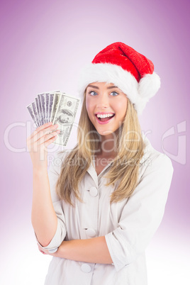 Festive blonde holding fan of dollars