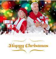 Composite image of happy festive couple with gifts