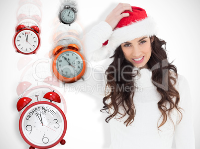 Composite image of confused brunette in santa hat