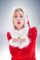 Festive blonde blowing a kiss