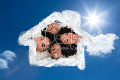Composite image of family on floor with heads together