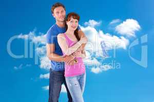 Composite image of couple hugging and holding brush