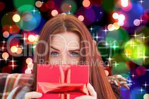 Composite image of woman holding gift