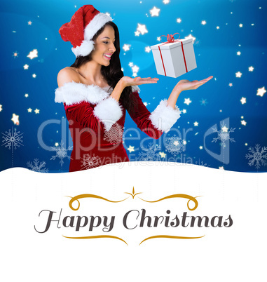 Composite image of pretty girl presenting in santa outfit