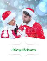 Composite image of festive young couple holding gift