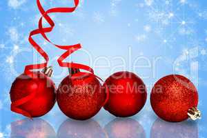 Composite image of four red christmas ball decorations