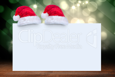 Composite image of santa hat on poster