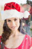 Composite image of portrait of a festive brunette at christmas