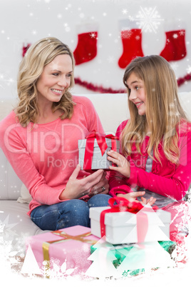 Composite image of festive mother and daughter with many gifts