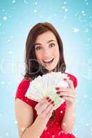 Composite image of excited brunette holding her cash