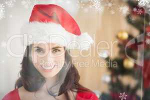 Composite image of festive brunette posing at christmas