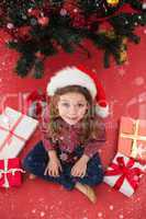 Composite image of festive little girl with gifts