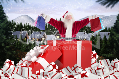 Composite image of santa standing in large gift