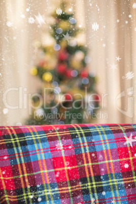 Composite image of warm blanket on the couch at christmas