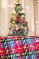 Composite image of warm blanket on the couch at christmas