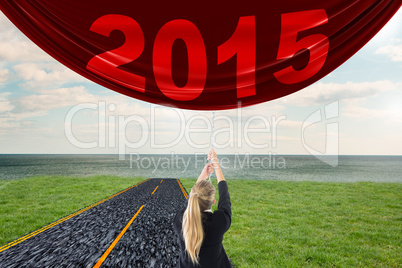 Composite image of businesswoman pulling a chain