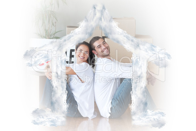 Composite image of happy young couple sitting on the floor