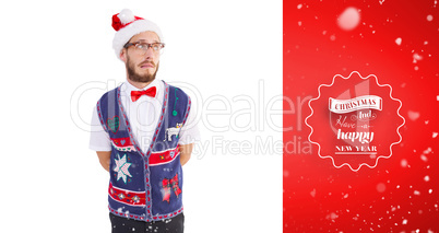 Composite image of geeky hipster in santa hat