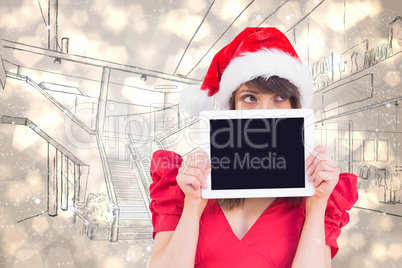 Composite image of festive brunette holding a tablet pc