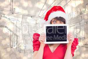 Composite image of festive brunette holding a tablet pc