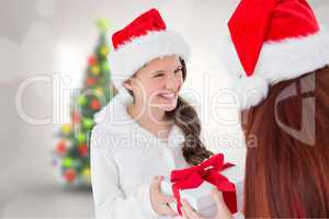 Composite image of mother and daughter with gift