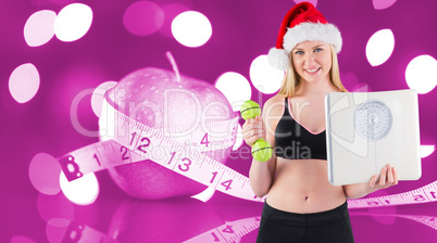 Composite image of festive fit blonde smiling at camera