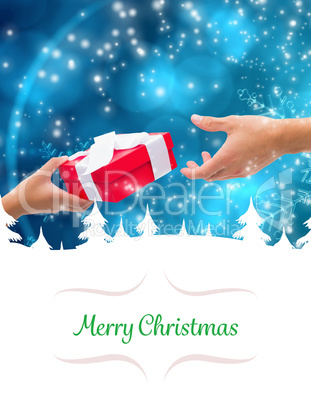 Composite image of couple passing a wrapped gift