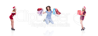 Composite image of festive brunette holding christmas gift