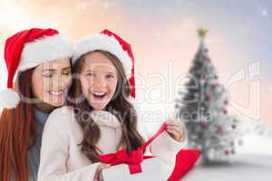 Composite image of mother and daughter opening gift