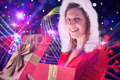 Composite image of smiling girl opening a gift and looking at th