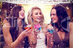 Composite image of pretty friends drinking cocktails together