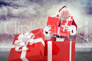 Composite image of santa standing in large gift