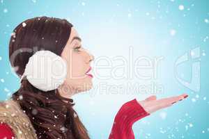 Composite image of brunette in winter clothes with hand out