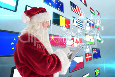 Composite image of santa uses a tablet pc