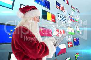 Composite image of santa uses a tablet pc