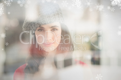 Composite image of portrait of a pretty brunette in grey hat