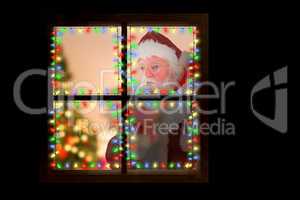 Composite image of santa claus carrying sack