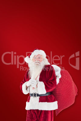 Composite image of santa carries his red bag