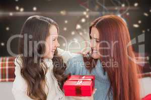 Composite image of mother and daughter with gift