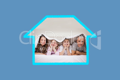 Composite image of playful family lying under a duvet