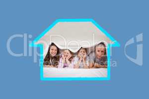 Composite image of playful family lying under a duvet