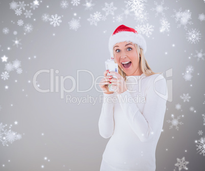Composite image of festive blonde holding her cash