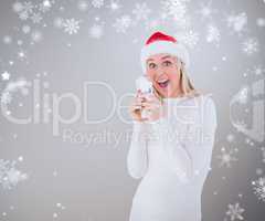 Composite image of festive blonde holding her cash