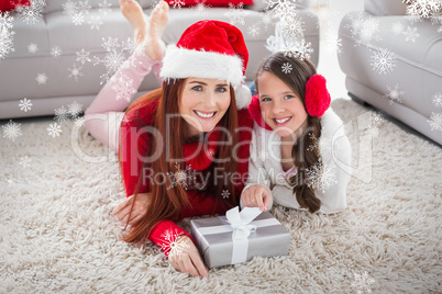 Composite image of festive mother and daughter smiling at camera