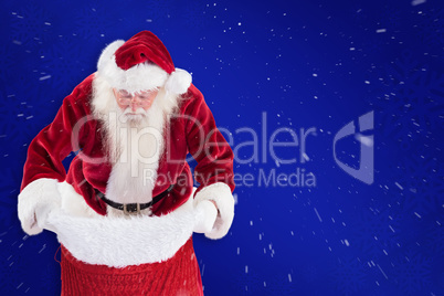 Composite image of santa looks in his bag