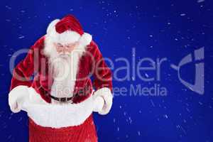 Composite image of santa looks in his bag