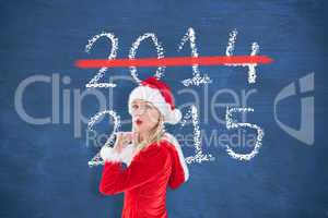 Composite image of festive blonde blowing a kiss