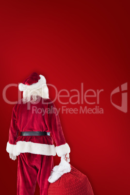 Composite image of santa carrying sack of gifts