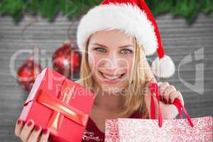 Composite image of woman smiling with christmas shopping