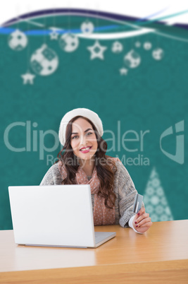 Composite image of smiling woman with credit card